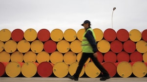 man walking barrels lubricants