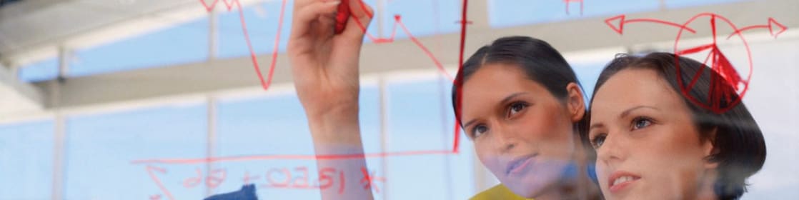 Businesswoman drawing graphs on glass