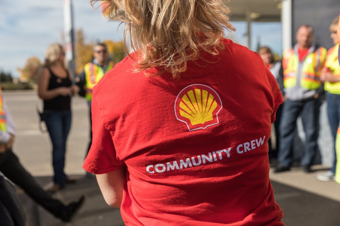 A Groundbirch employee wears a red shirt with the words ‘community crew’ across the back.