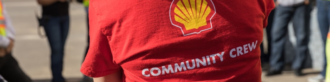 A Groundbirch employee wears a red shirt with the words ‘community crew’ across the back.