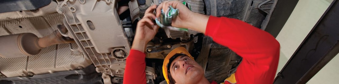 employee doing fitting of parts in car