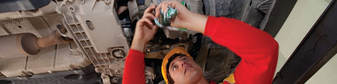 employee doing fitting of parts in car