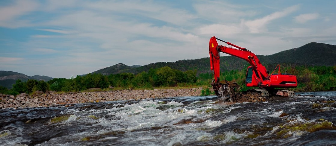 Excavator working in water