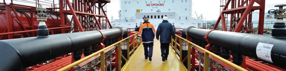 Shell employee walking along on a tanker 