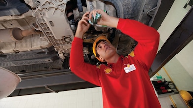 employee doing fitting of parts in car