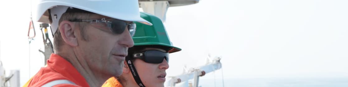 man and woman watching from ship