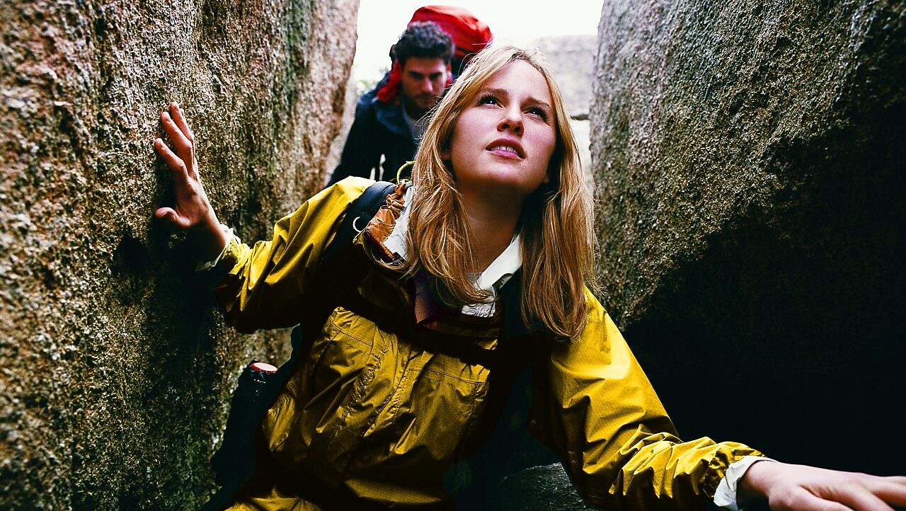 Two People Orienteering Between Rocks