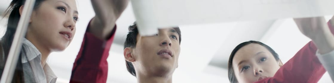 man showing bluprint to colleagues