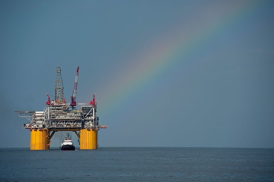 Plateforme offshore de Shell avec un arc-en-ciel en arrière-plan.