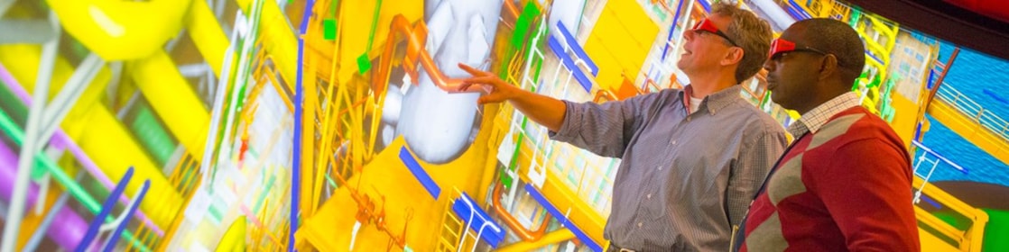 Deux employés de Shell avec des lunettes 3D consultant une carte interactive