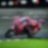 A red Ducati MotoGP bike taking a sharp turn on a race track